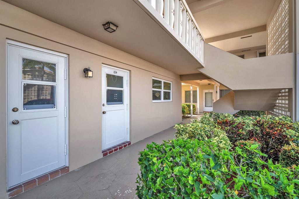 2131 Northeast 42nd Court, Unit 104E Lighthouse Point, FL 33064 - Photo 2 of 31 a view of a house with entryway and stairs