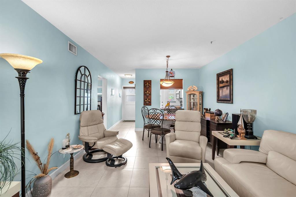 2131 Northeast 42nd Court, Unit 104E Lighthouse Point, FL 33064 - Photo 23 of 31 a living room with furniture and a window