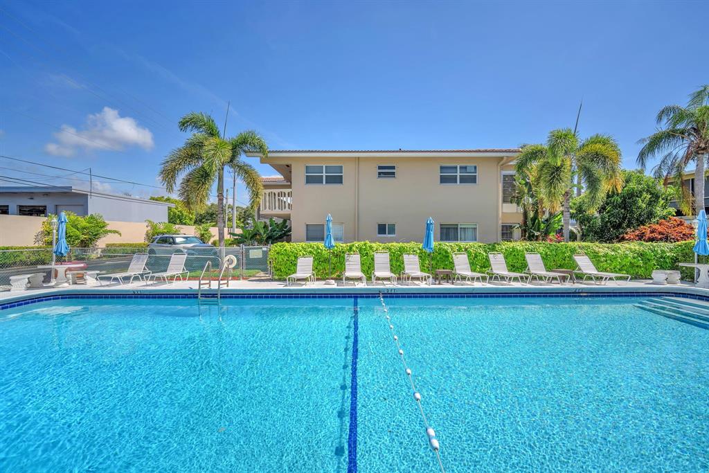 2131 Northeast 42nd Court, Unit 104E Lighthouse Point, FL 33064 - Photo 30 of 31 a view of swimming pool with outdoor seating and yard in back