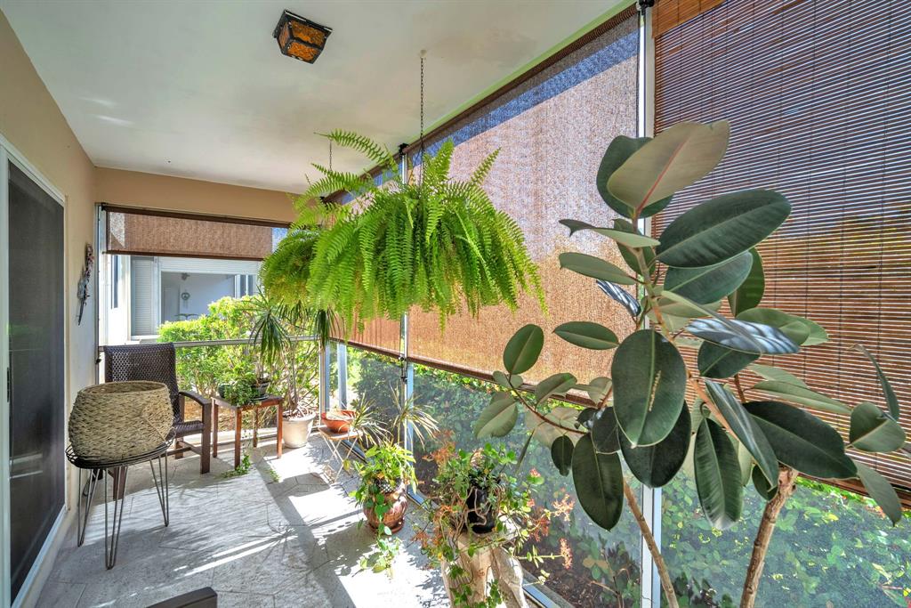 2131 Northeast 42nd Court, Unit 104E Lighthouse Point, FL 33064 - Photo 4 of 31 a house view with a garden space