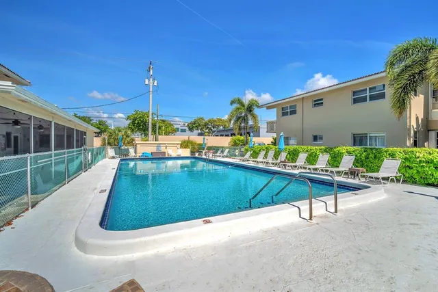 a view of a swimming pool with a lounge chairs