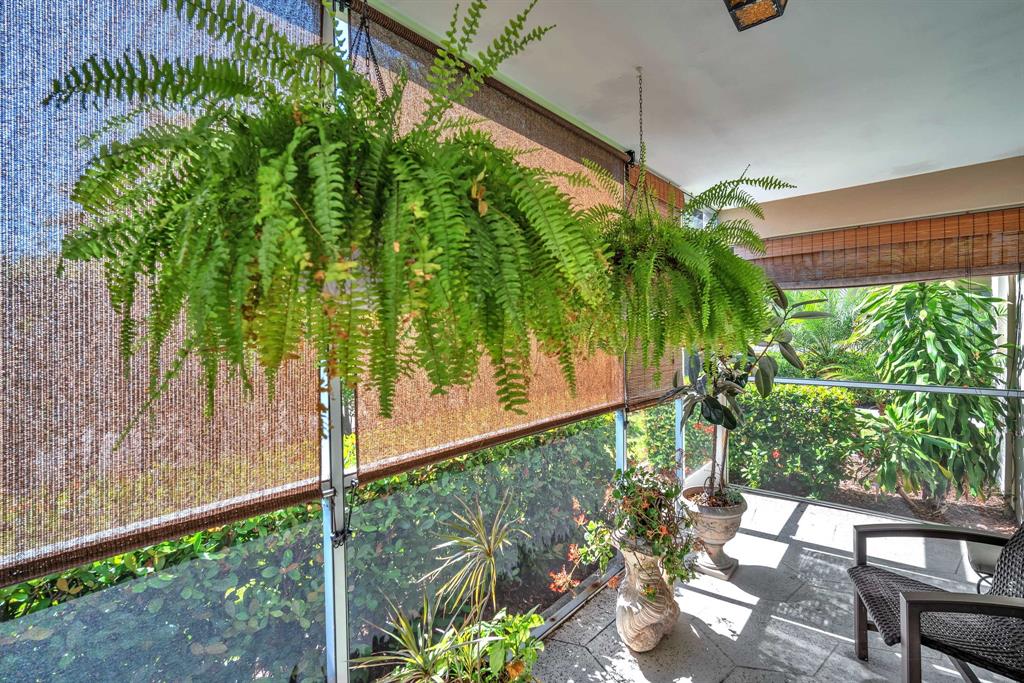 2131 Northeast 42nd Court, Unit 104E Lighthouse Point, FL 33064 - Photo 6 of 31 a backyard of a house with a garden and outdoor seating