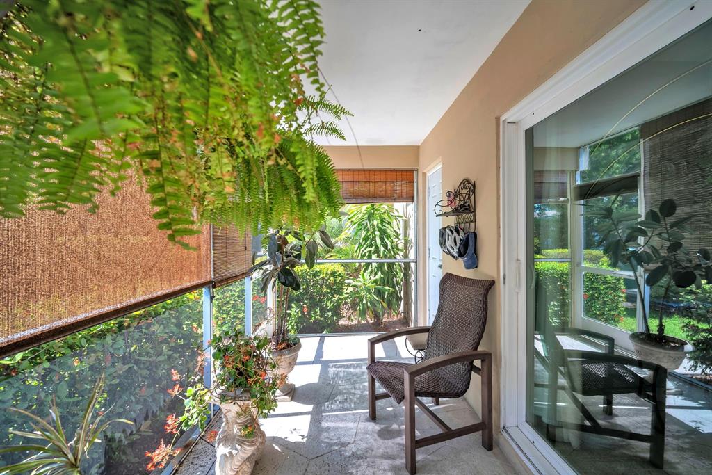 2131 Northeast 42nd Court, Unit 104E Lighthouse Point, FL 33064 - Photo 8 of 31 a view of a chair and table in backyard of the house