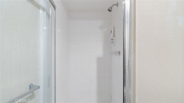 a view of a hallway with wooden floor and a fireplace