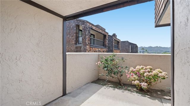 a bedroom with 2 bed and a painting on the wall