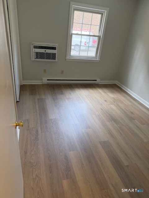 239 Old Farms Road, Unit 16D Avon, CT 06001 - Photo 10 of 16 an empty room with wooden floor and windows