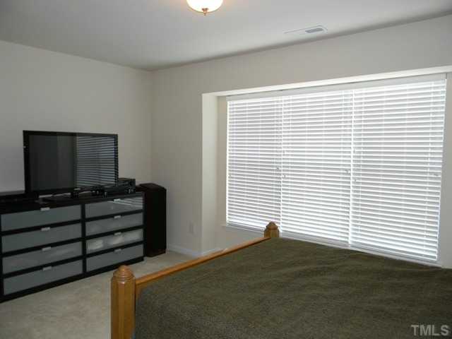 2018 Kedvale Avenue Raleigh, NC 27617 - Photo 11 of 18 a bedroom with a bed and a flat screen tv
