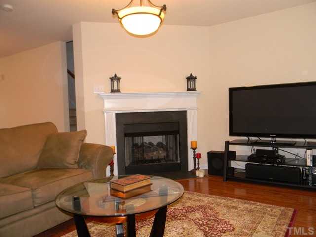 2018 Kedvale Avenue Raleigh, NC 27617 - Photo 4 of 18 a living room with furniture a fireplace and a flat screen tv