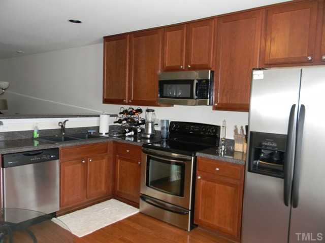 2018 Kedvale Avenue Raleigh, NC 27617 - Photo 8 of 18 a kitchen with granite countertop a refrigerator stove and microwave
