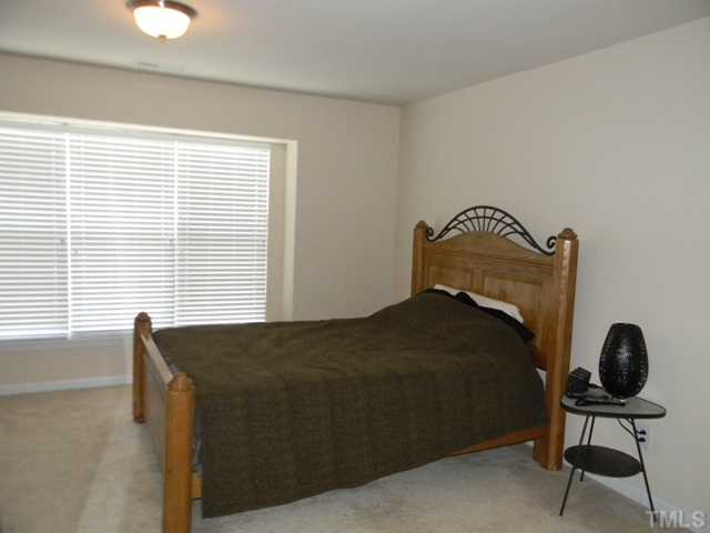 2018 Kedvale Avenue Raleigh, NC 27617 - Photo 10 of 18 a bedroom with a bed and a chair