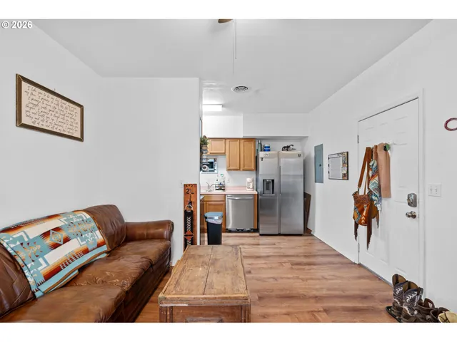 a living room with furniture and a kitchen view