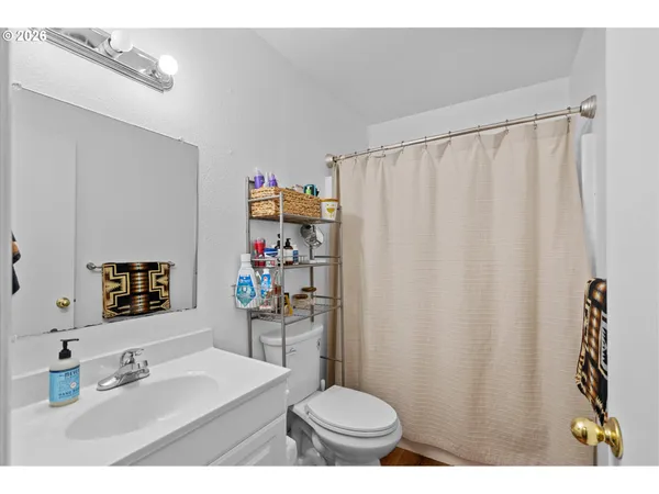 a bathroom with a sink toilet and a mirror