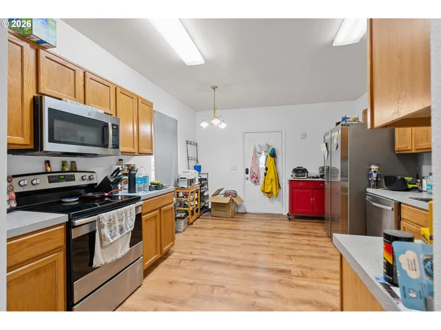 a kitchen that has a lot of cabinets a sink and appliances in it