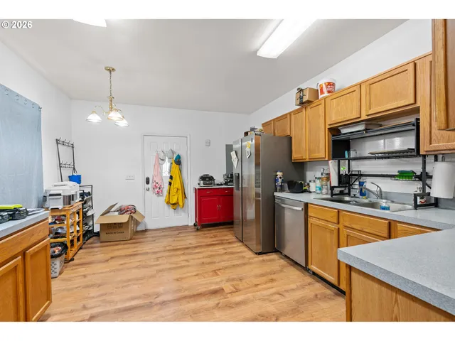 a kitchen with stainless steel appliances kitchen island granite countertop a sink dishwasher stove and cabinets