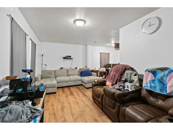 a living room with furniture and wooden floor