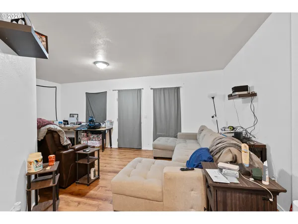 a living room with furniture a piano and a flat screen tv