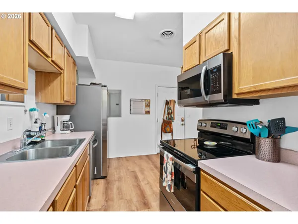 a kitchen with a stove a sink and a microwave