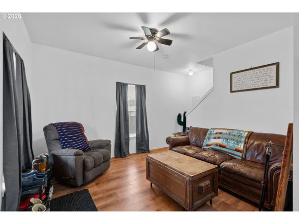 a living room with furniture and a ceiling fan