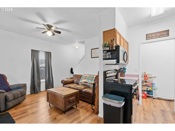 a living room with furniture and wooden floor