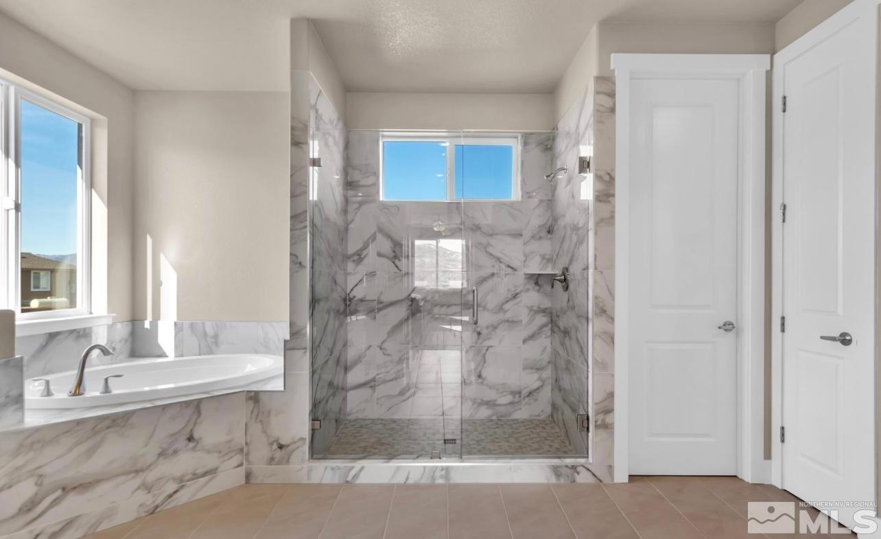200 Paloma Ranch Court Reno, NV 89510 - Photo 18 of 27 a bathroom with a granite countertop sink a mirror and a bathtub