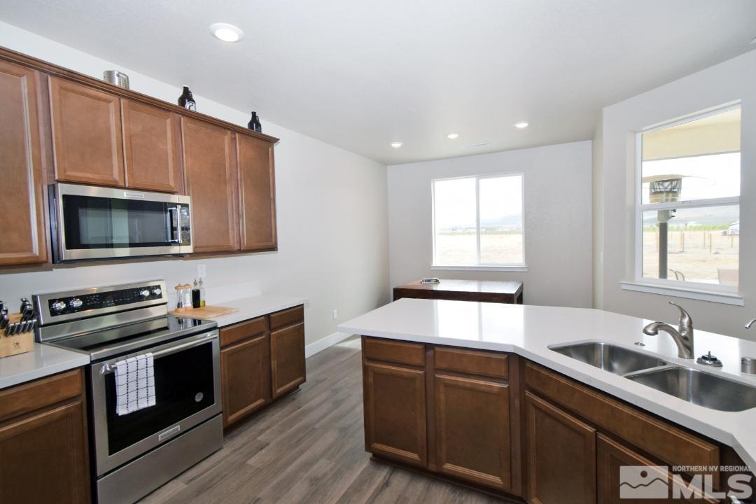 200 Paloma Ranch Court Reno, NV 89510 - Photo 9 of 27 a kitchen with granite countertop a sink a stove microwave and cabinets
