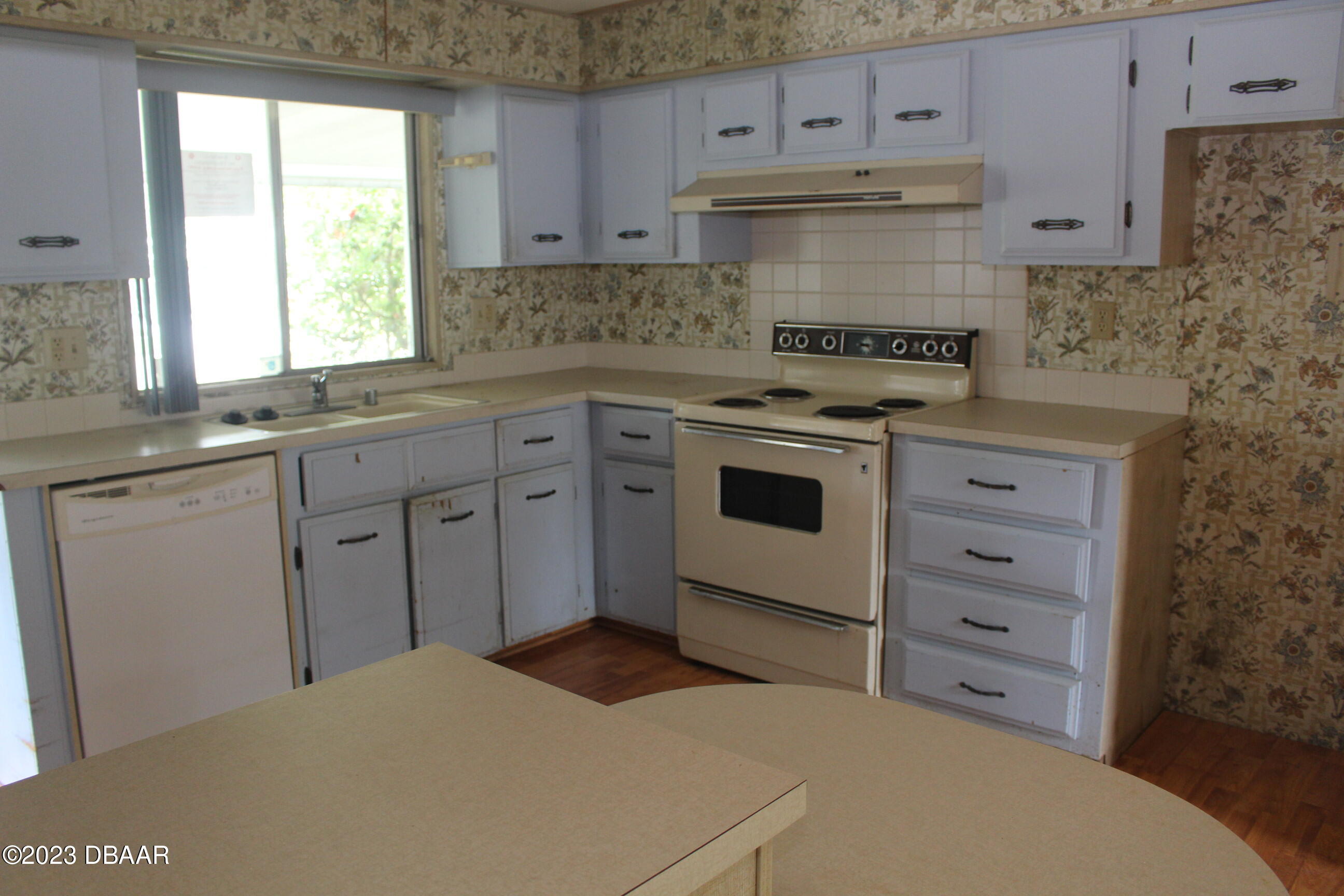 780 Rolling Hills Drive Port Orange, FL 32129 - Photo 1 of 15 a kitchen with cabinets appliances and a window