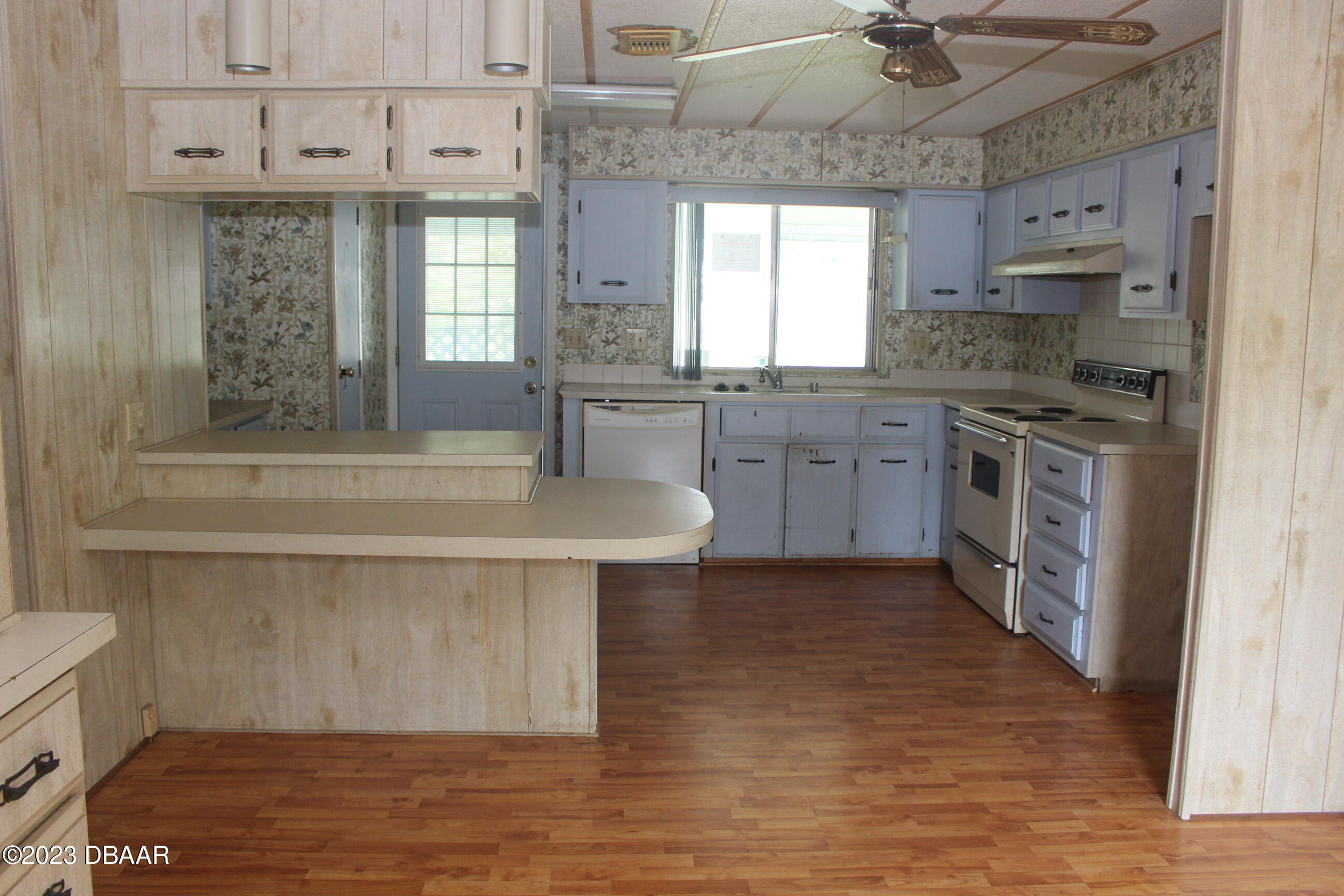 780 Rolling Hills Drive Port Orange, FL 32129 - Photo 11 of 15 a kitchen with stainless steel appliances granite countertop a sink a stove counter space and cabinets