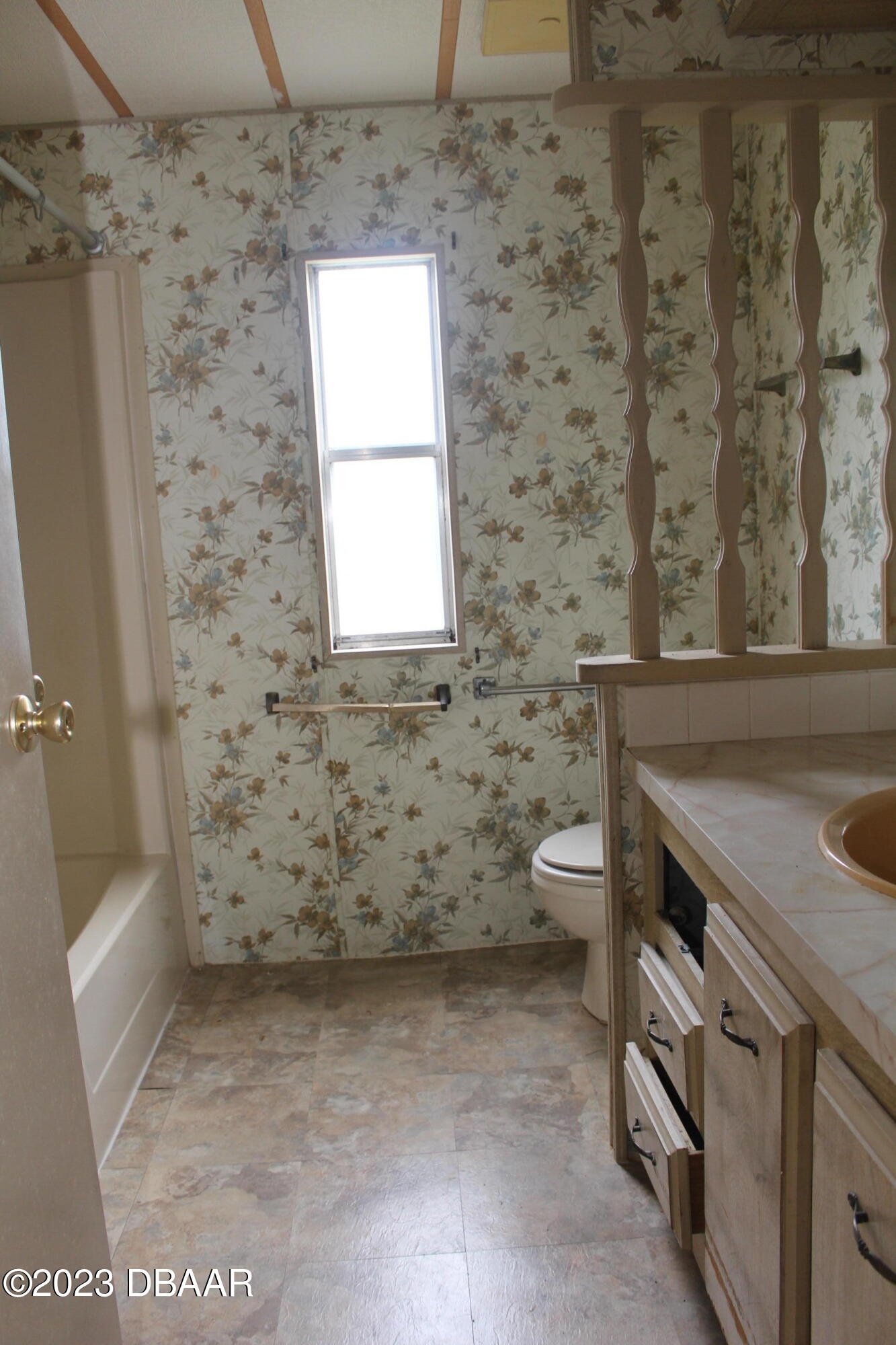 780 Rolling Hills Drive Port Orange, FL 32129 - Photo 13 of 15 a bathroom with a granite countertop sink a toilet and a bathtub