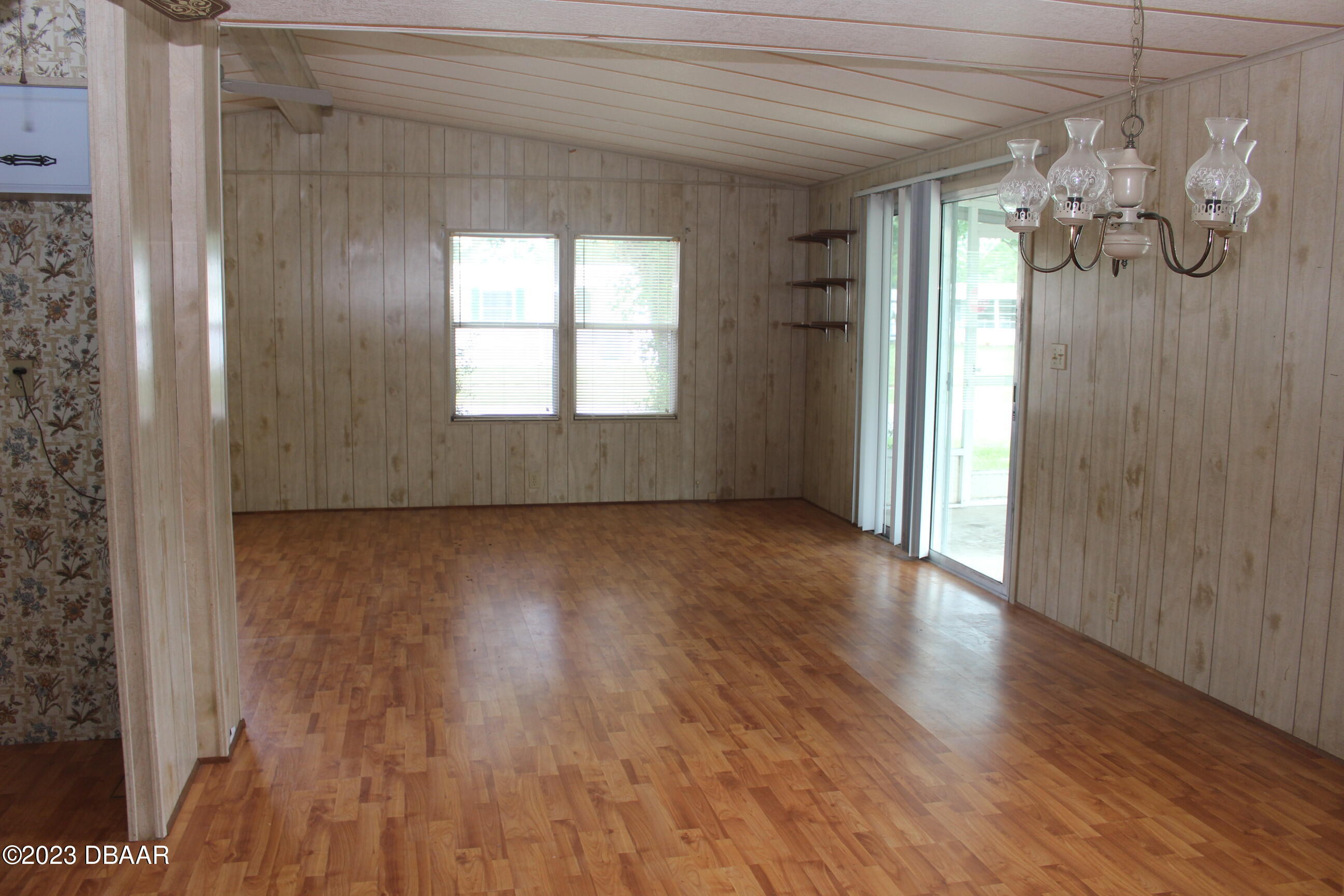 780 Rolling Hills Drive Port Orange, FL 32129 - Photo 5 of 15 a view of a room with wooden floor and windows
