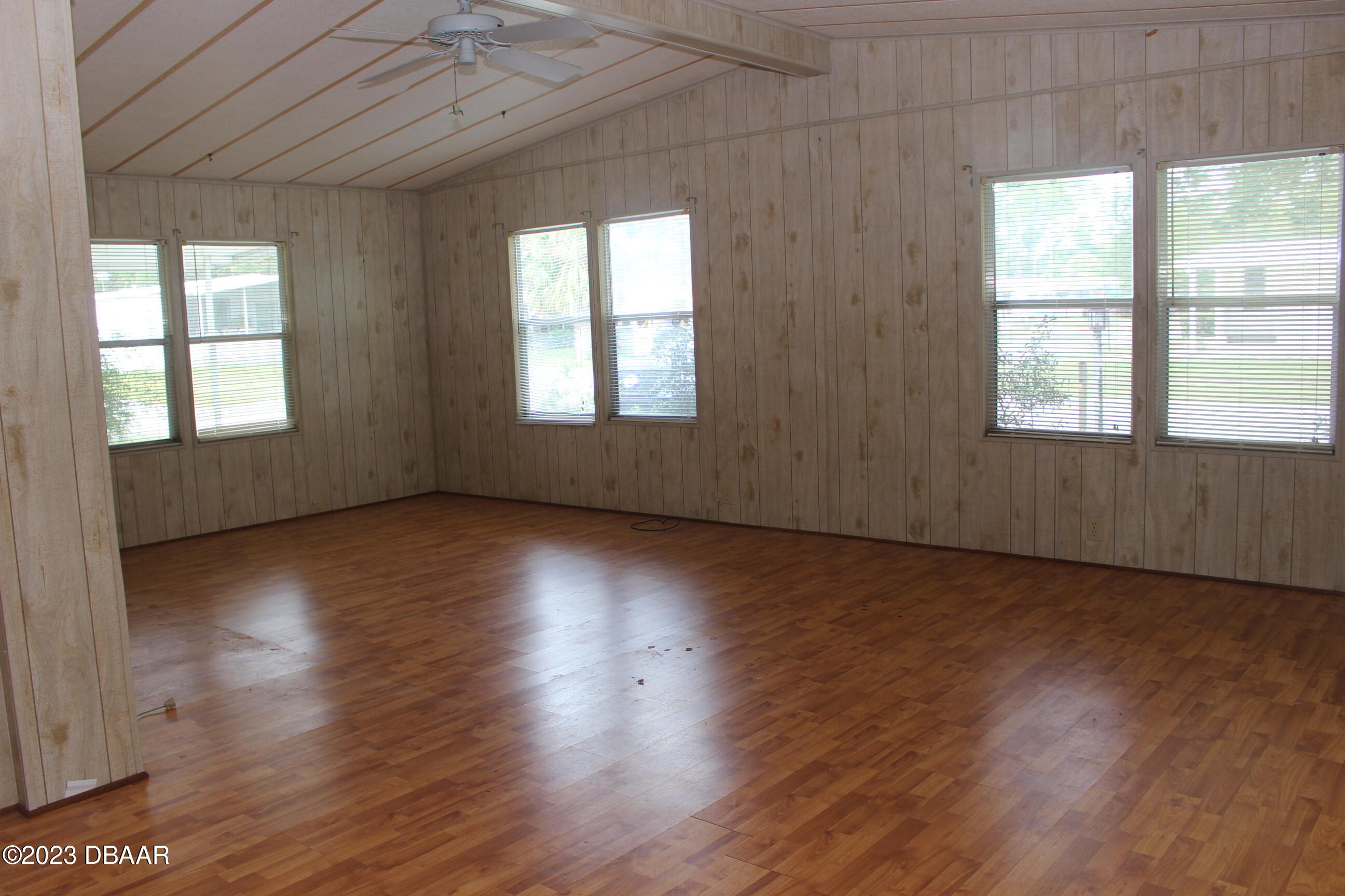 780 Rolling Hills Drive Port Orange, FL 32129 - Photo 6 of 15 an empty room with wooden floor and windows