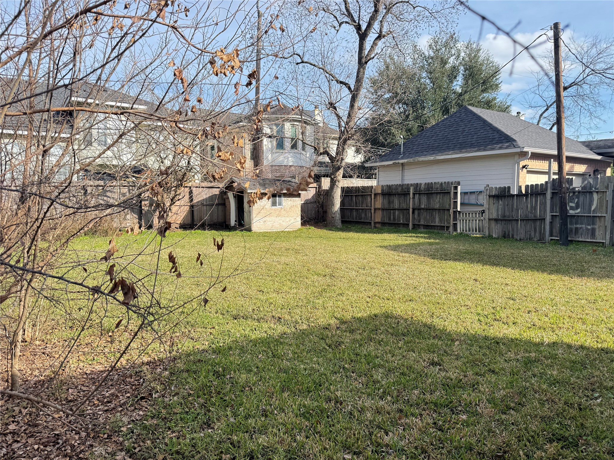 7309 South Rice Avenue Bellaire, TX 77401 - Photo 5 of 6 a view of a house with a yard covered with snow in front of house