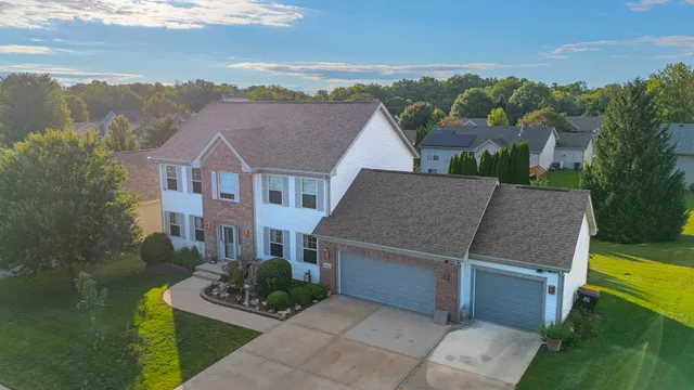 a aerial view of a house with a yard