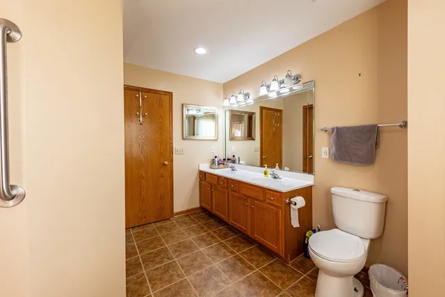 a bathroom with a toilet sink and mirror
