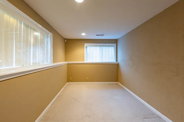 an empty room with a empty space and windows