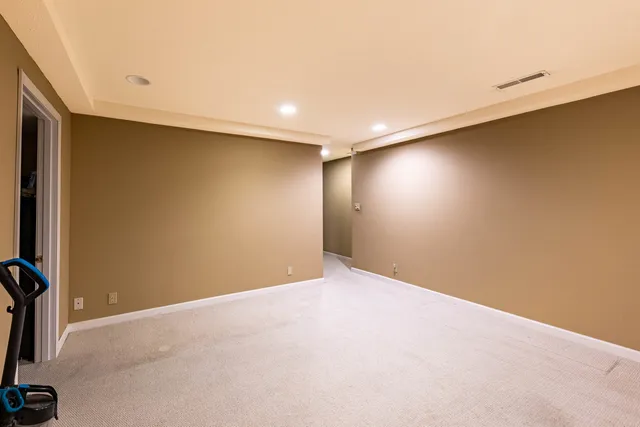 an empty room with a empty space and windows