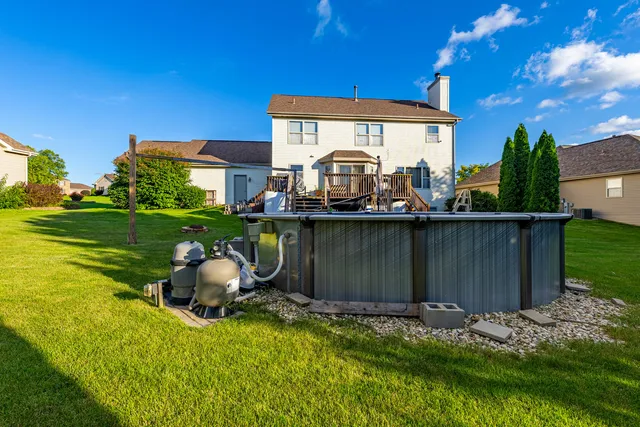 a view of a house with backyard and sitting area
