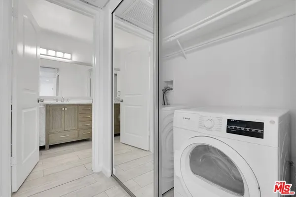a view of a hallway with washer and dryer
