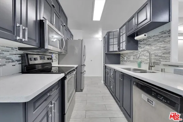 a kitchen with stainless steel appliances granite countertop a sink and cabinets