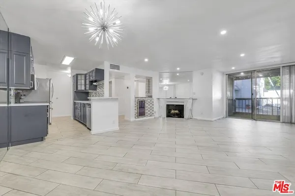 a view of kitchen with a sink cabinets and window