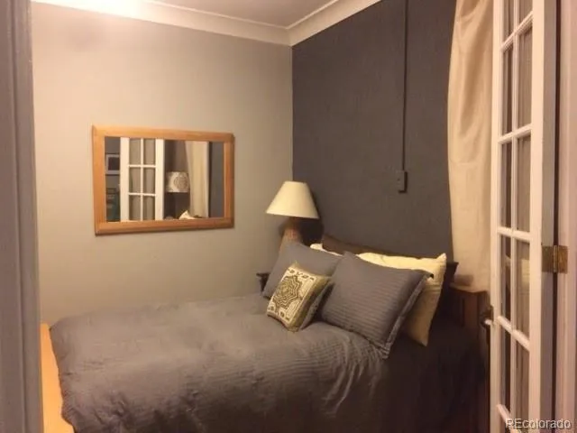 a bed sitting in a bedroom next to a window
