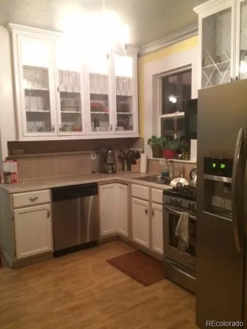 a kitchen with stainless steel appliances granite countertop a stove and a sink