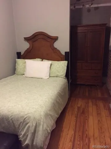 a large bed sitting in a bedroom next to a wooden closet