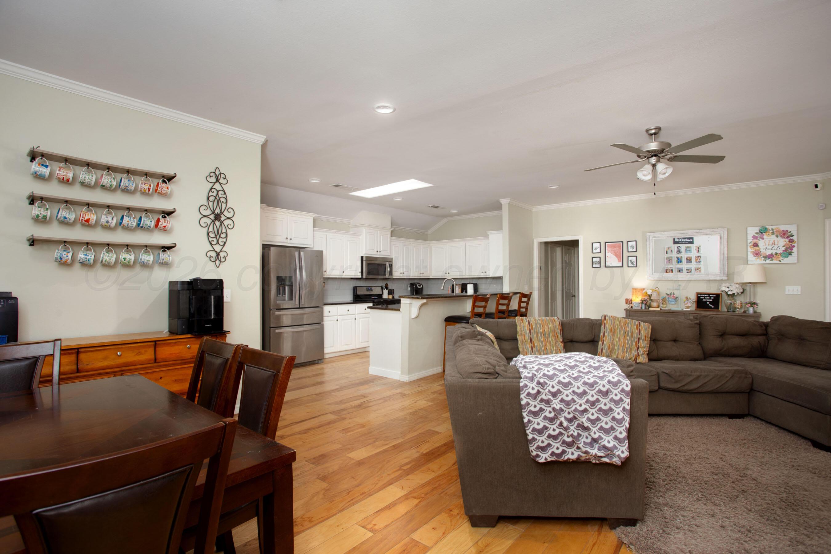 9505 Perry Avenue Amarillo, TX 79119 - Photo 6 of 21 a living room with furniture kitchen view and a chandelier