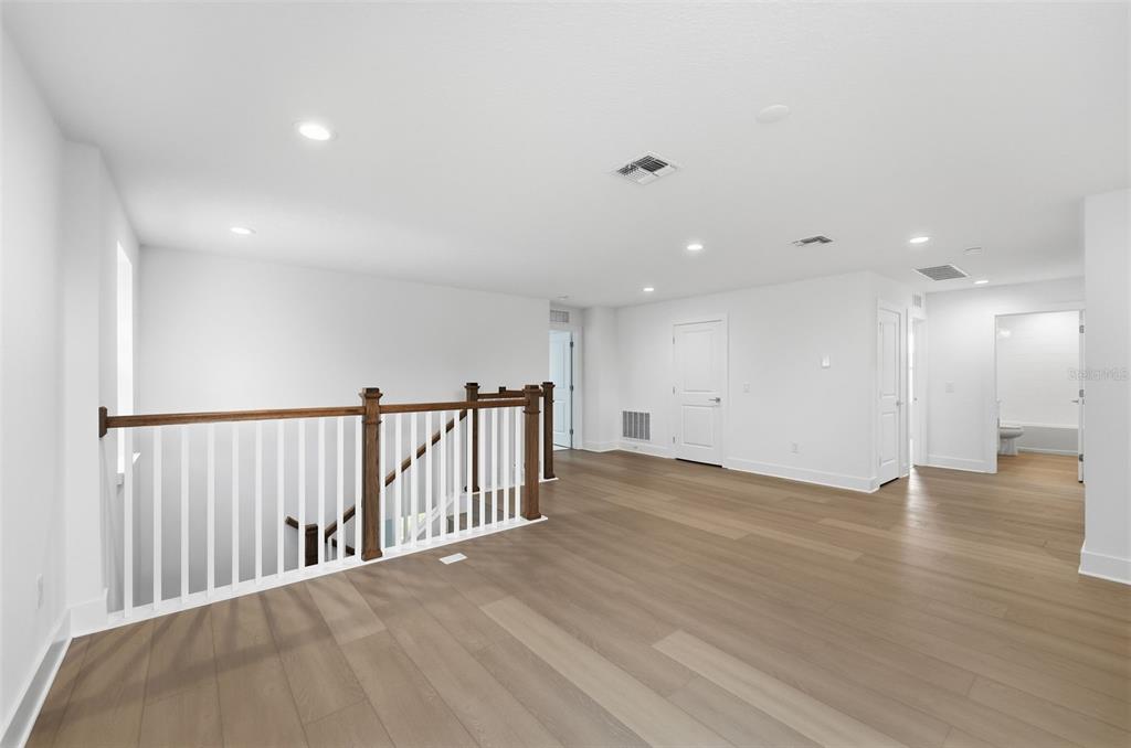 2430 Park Ridge Street Apopka, FL 32712 - Photo 24 of 49 a view of an empty room with wooden floor