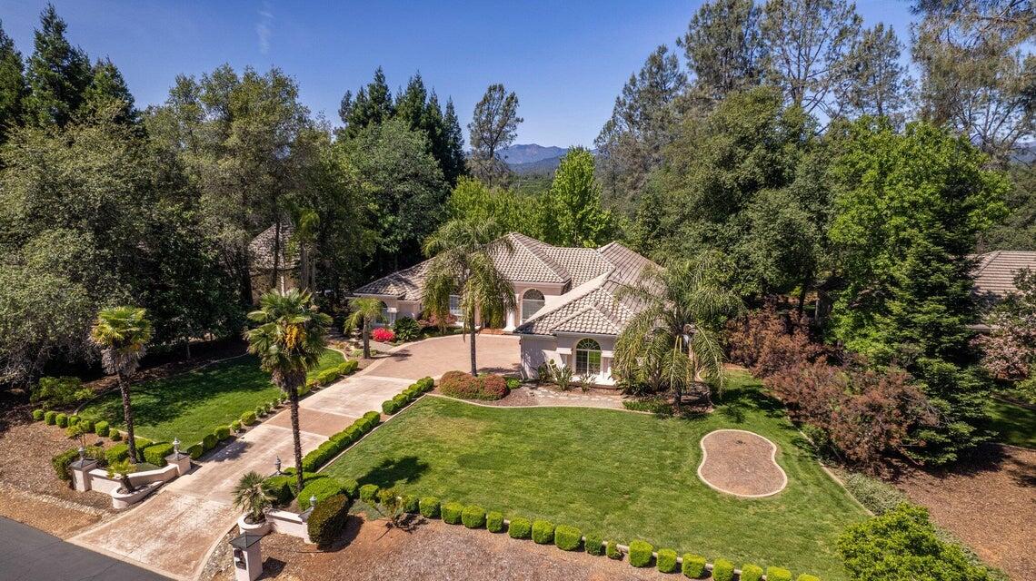 an aerial view of a house with a yard