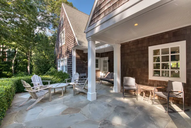 a view of a patio with table and chairs and potted plants