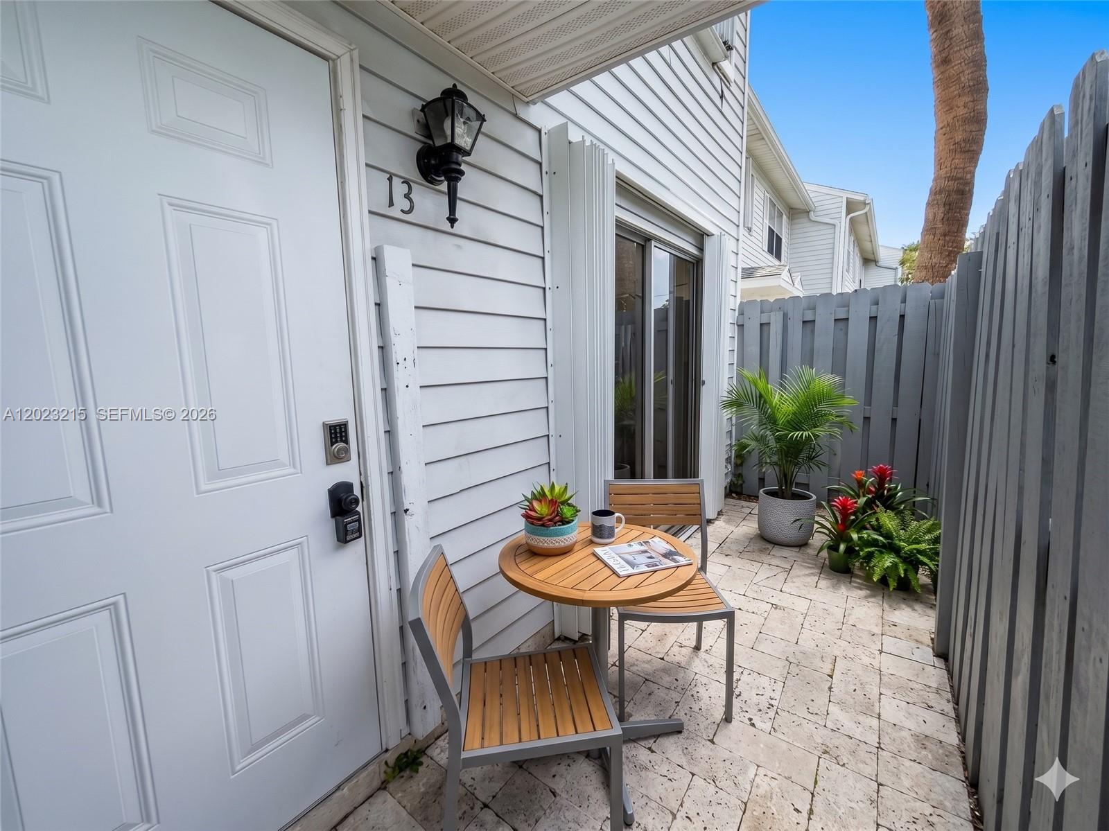 13 Southwest 3rd Street, Unit 13 Pompano Beach, FL 33060 - Photo 2 of 44 a view of a patio with table and chairs and potted plants
