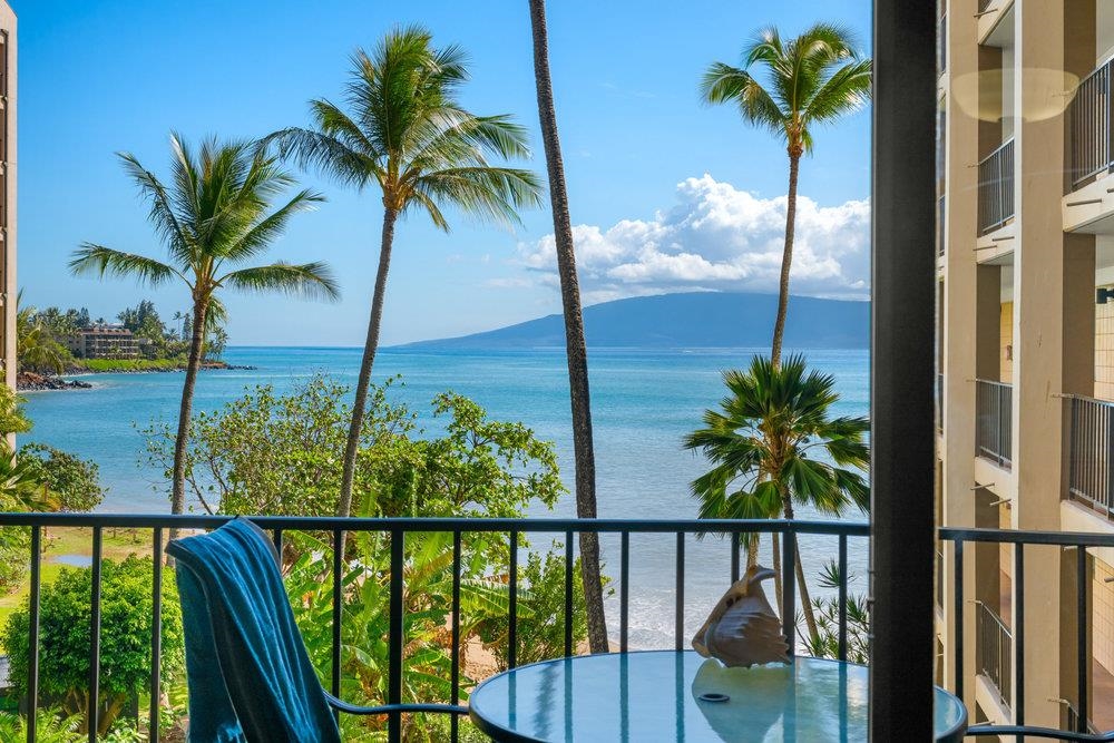 a view of a balcony with floor to ceiling window and wooden floor