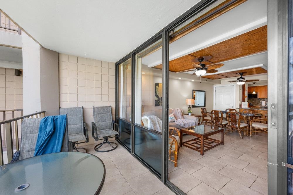 4327 Lower Honoapiilani Road, Unit 403 Lahaina, HI 96761 - Photo 15 of 42 a dining room with furniture and a floor to ceiling window