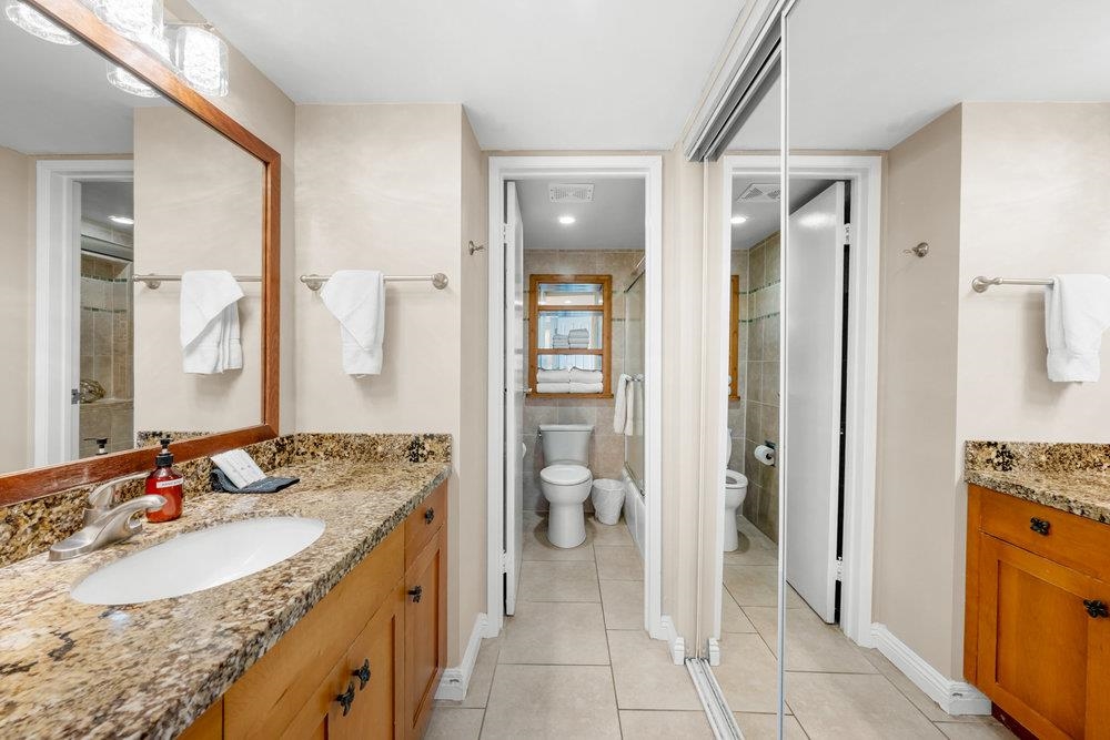 4327 Lower Honoapiilani Road, Unit 403 Lahaina, HI 96761 - Photo 18 of 42 a spacious bathroom with a granite countertop sink and a mirror